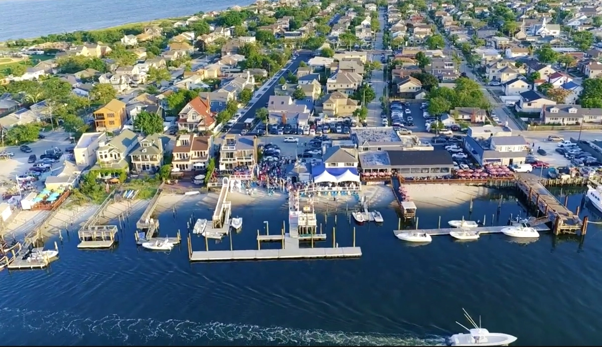 The Buoy Bar waterfront restaurant in Point Lookout, New York, with outdoor dining, boats, and Reynolds Channel views